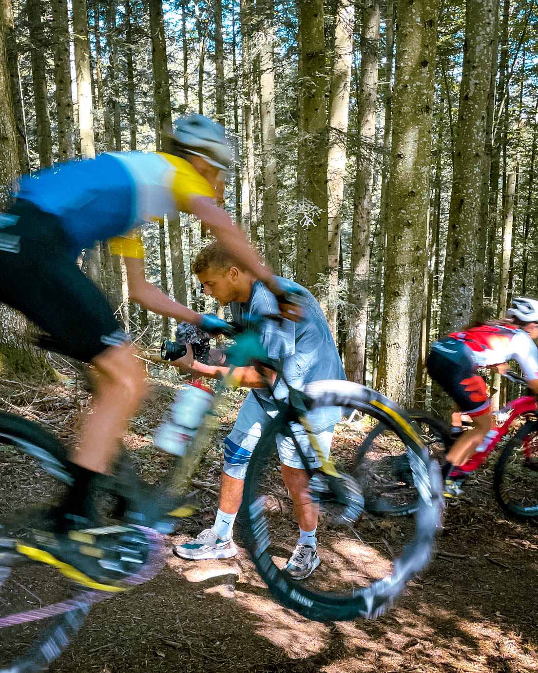 Mountain biker riding close to a cameraman